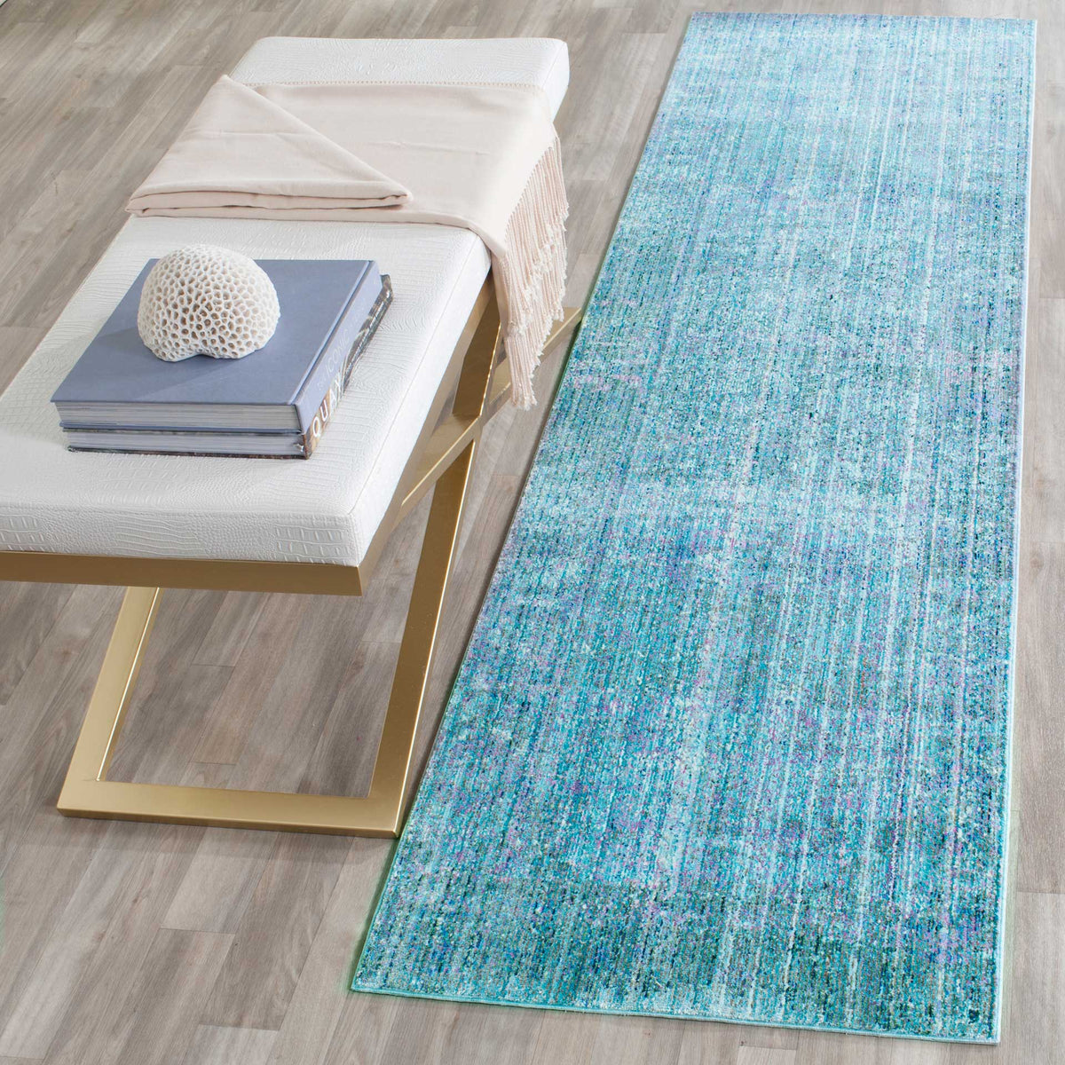 Bright turquoise runner adds a colorful, distressed accent beside a neutral bench