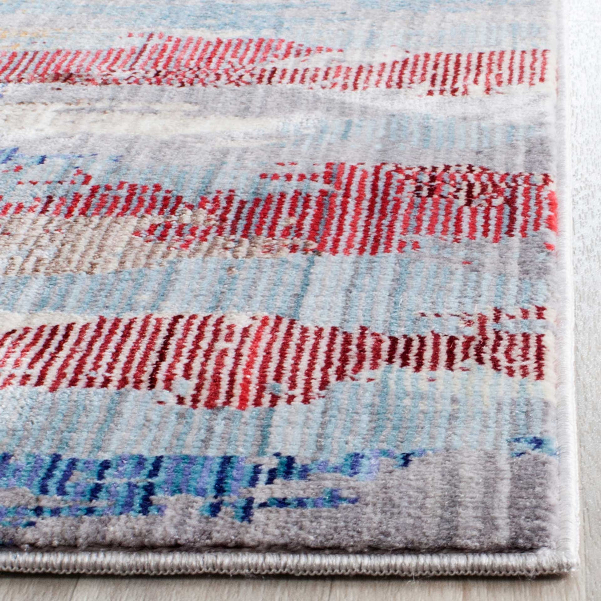 Textured red and blue streaks meet a neatly bound edge on this low-profile runner