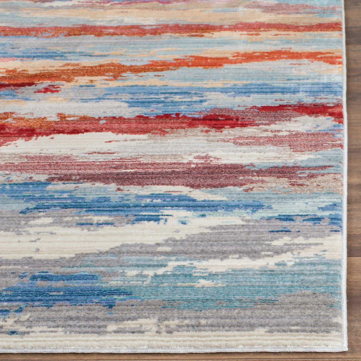Fine red and blue bands cross a pale ground, finished with a clean, narrow rug border.