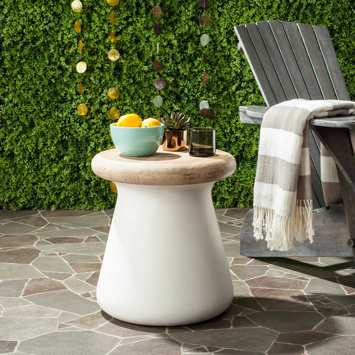 Ivory concrete accent table pairs a natural wood top with a sturdy base for outdoor lounging