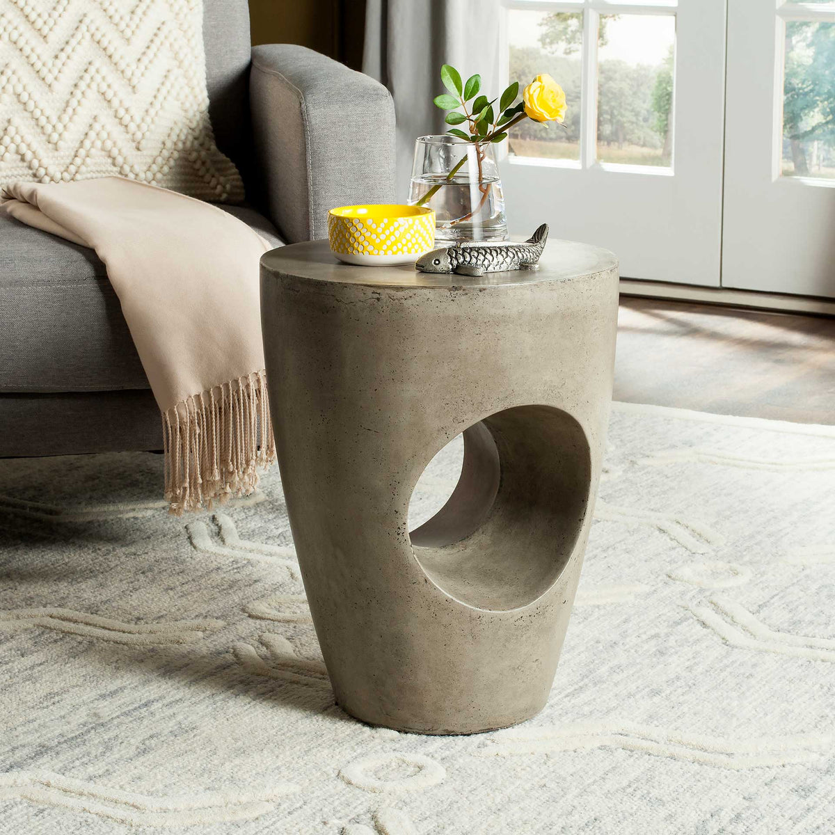 Dark gray concrete accent table with a hollow center and a top for drinks and flowers