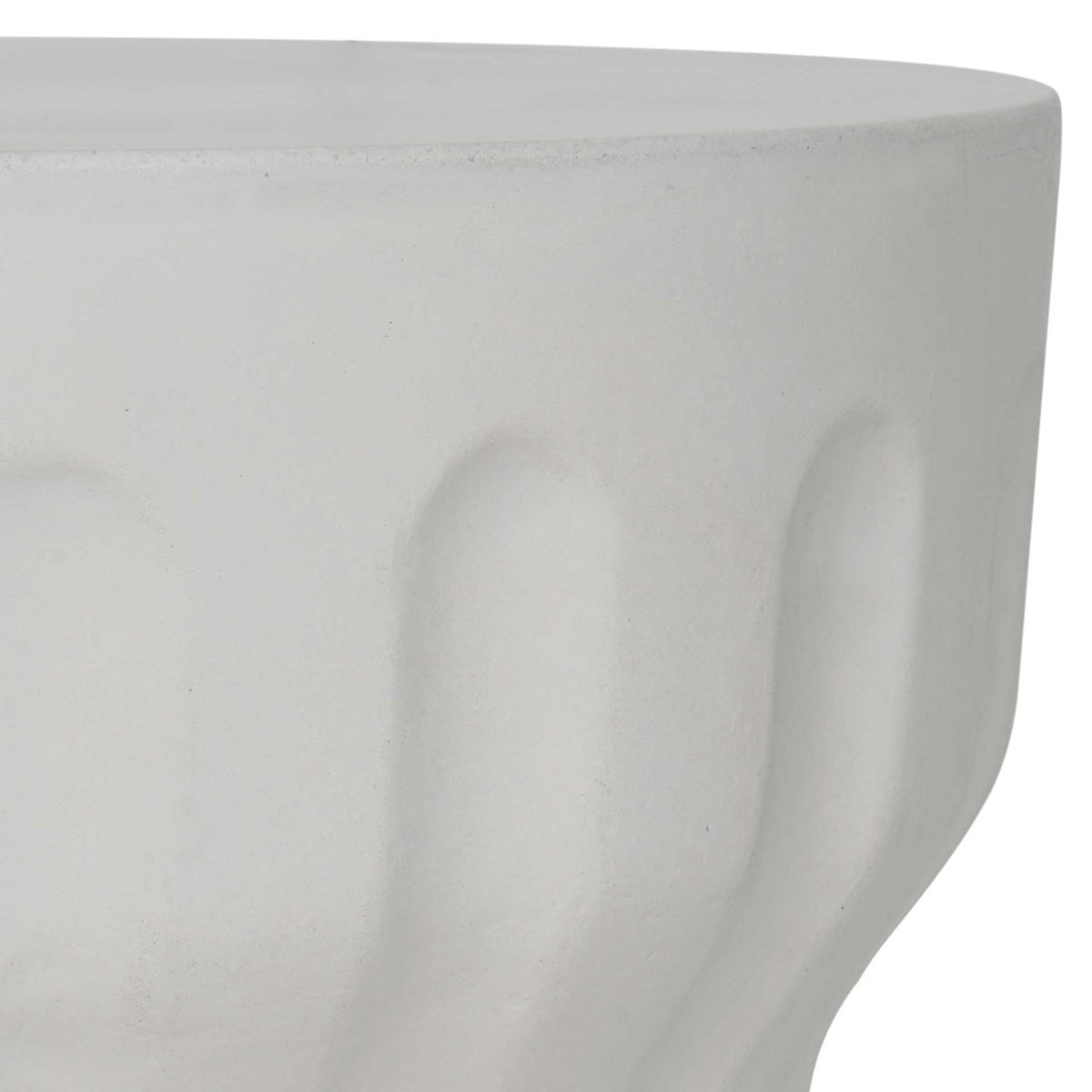 Smooth ivory concrete top meets softly sculpted fluting around its curved sides