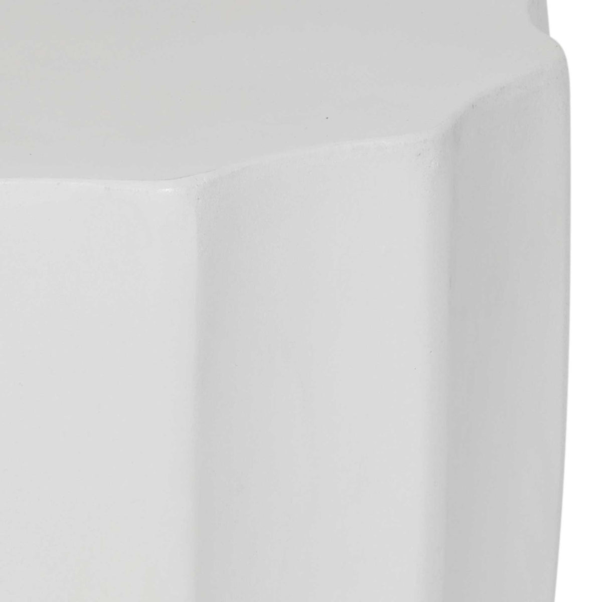 Smooth ivory tabletop meets broad, gently curved flutes along the concrete sides