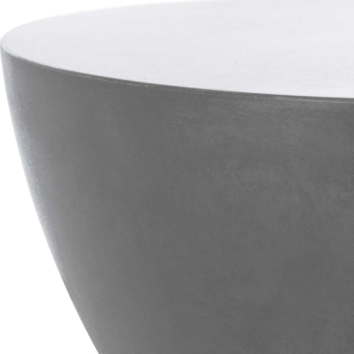 Smooth dark gray concrete gives the round tabletop a clean edge and subtly textured finish