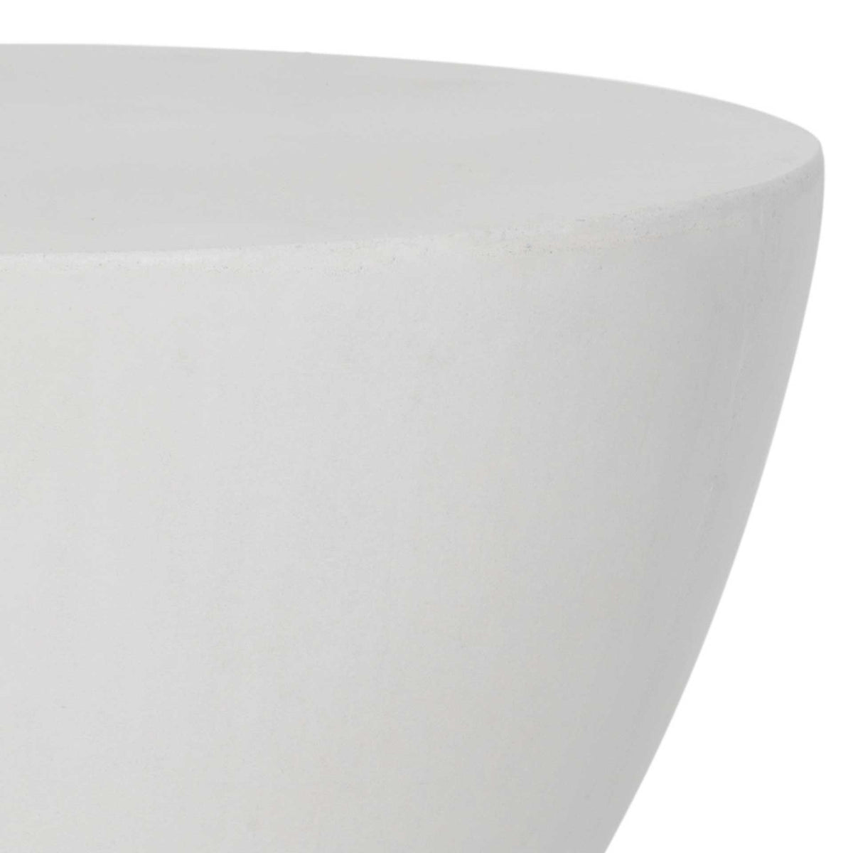 Smooth ivory concrete curves beneath a broad round tabletop with a clean, understated edge