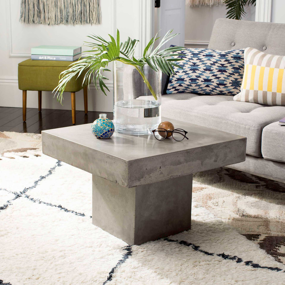 A slab-like top and sturdy block base give this gray concrete coffee table sculptural appeal.