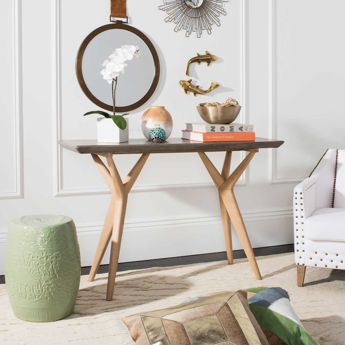 A concrete-and-oak console displays decor beneath a wall mirror