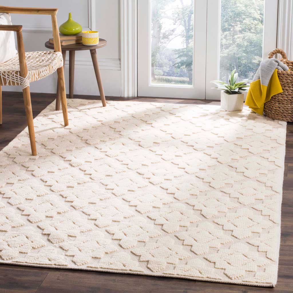 Ivory geometric rug adds soft texture and an inviting feel beside natural wood furniture