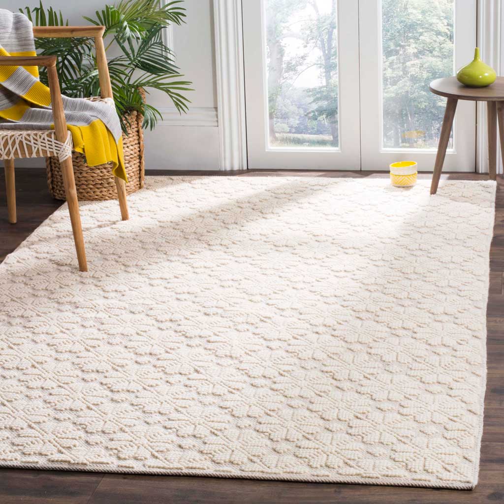 An ivory geometric rug lends cozy texture and understated warmth beneath everyday furnishings
