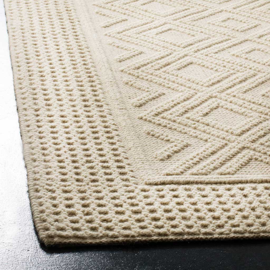 Raised diamond lines and a nubby dotted border give the ivory rug rich texture