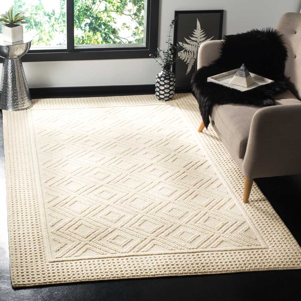 A softly textured ivory rug with a framed diamond pattern warms the living room