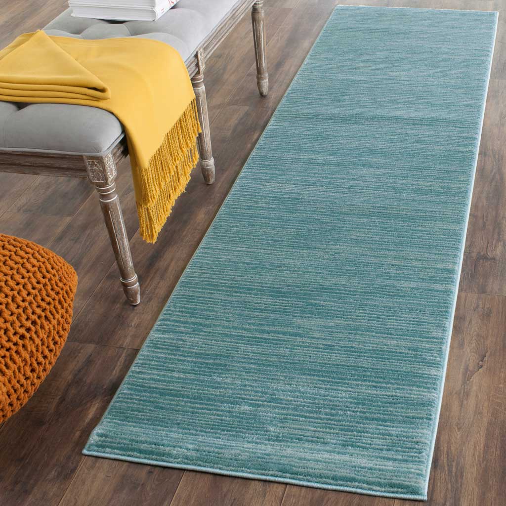 Cool aqua runner softens hardwood floors with a gently striated design