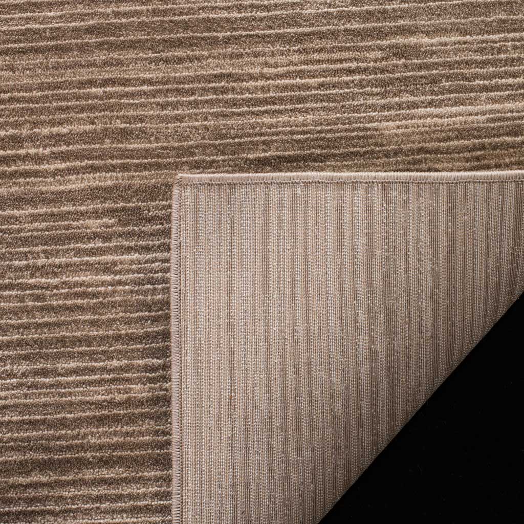 A ribbed cotton backing supports the rug's warm brown, softly striated pile.