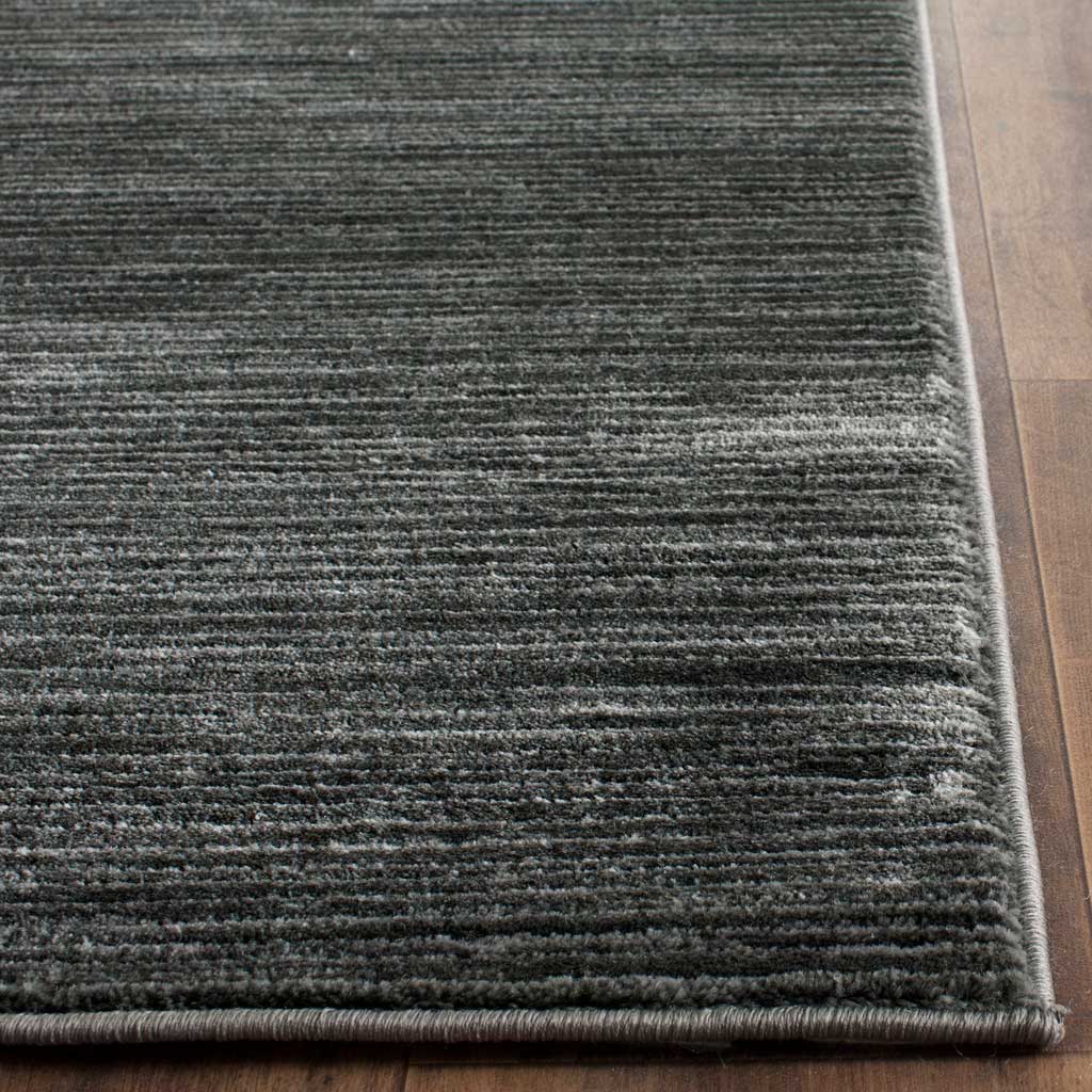 Deep gray pile and a neatly bound corner highlight subtle linear texture