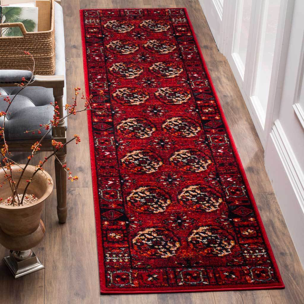 Vivid red runner showcases cream-accented medallions framed by a richly patterned edge