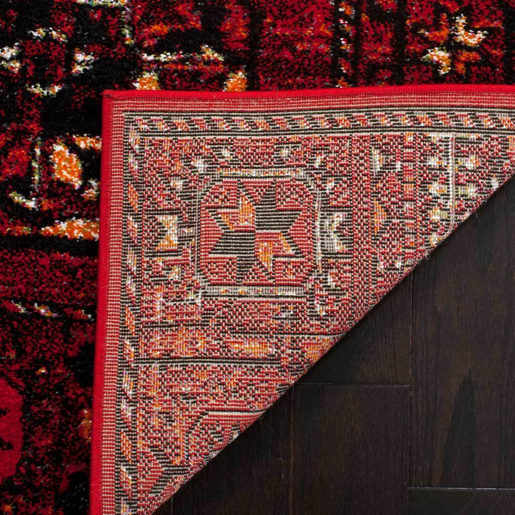 Woven reverse and red edge binding finish the medallion-patterned rug
