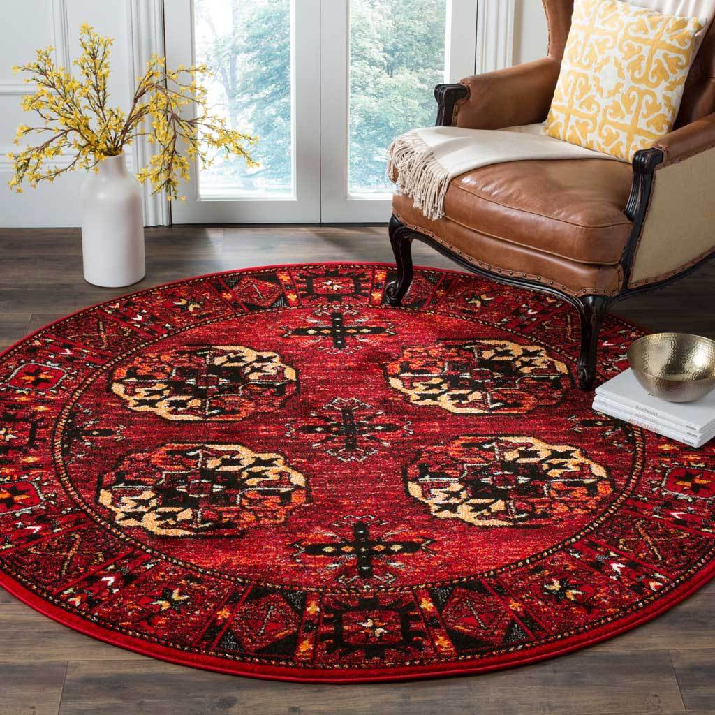 Four cream-accented medallions stand out across this red rug beneath a leather chair.