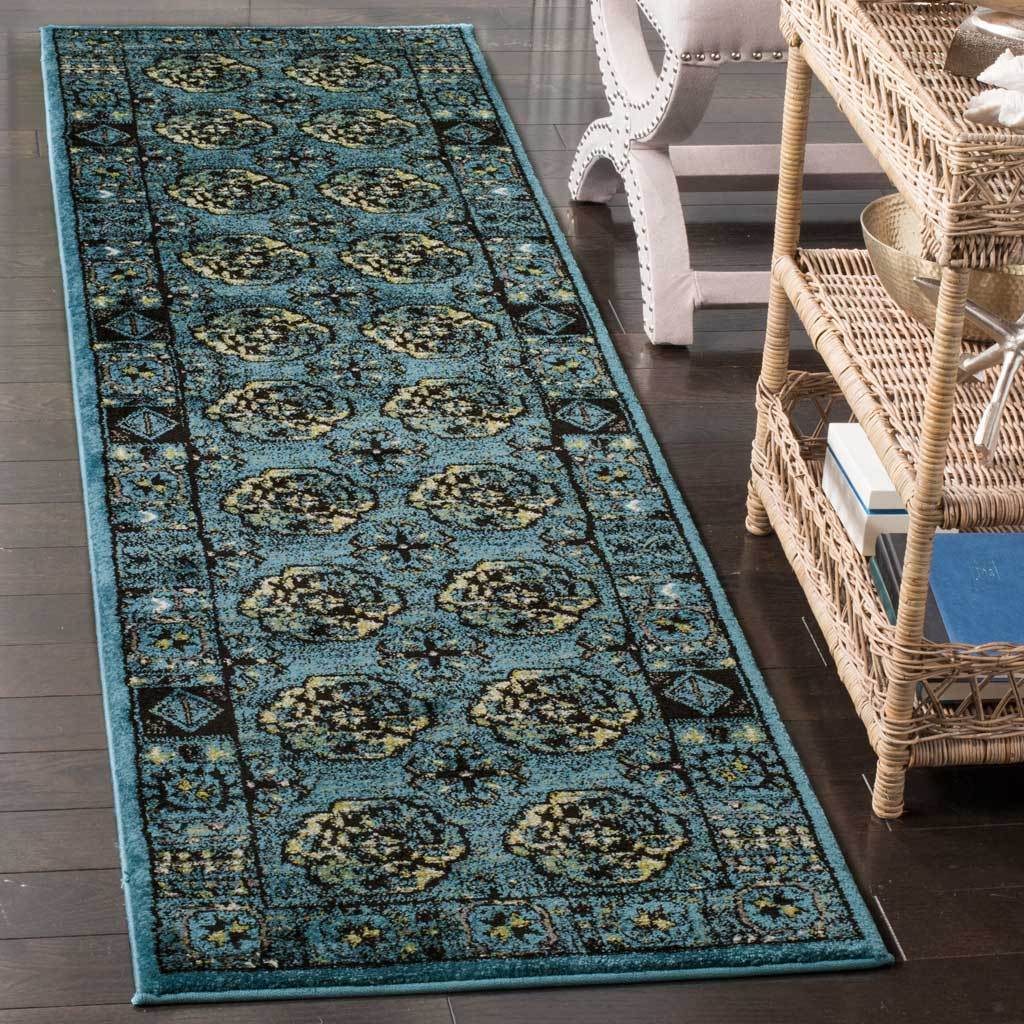 Turquoise-blue runner with ornate floral medallions and patterned edges