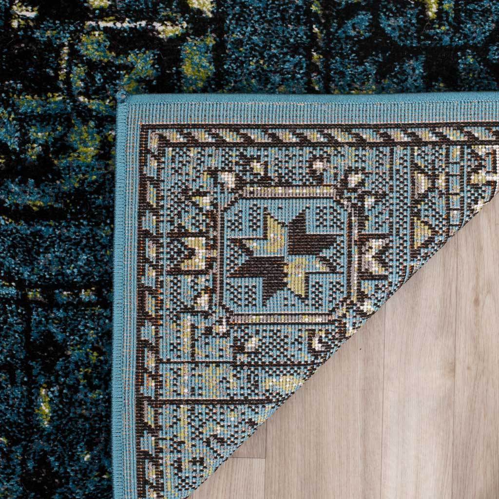 Woven underside and blue bound edge add a neat finish to the patterned rug