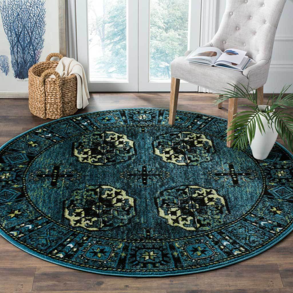 Four ornate medallions bring contrast to a deep blue round rug beneath a light accent chair.