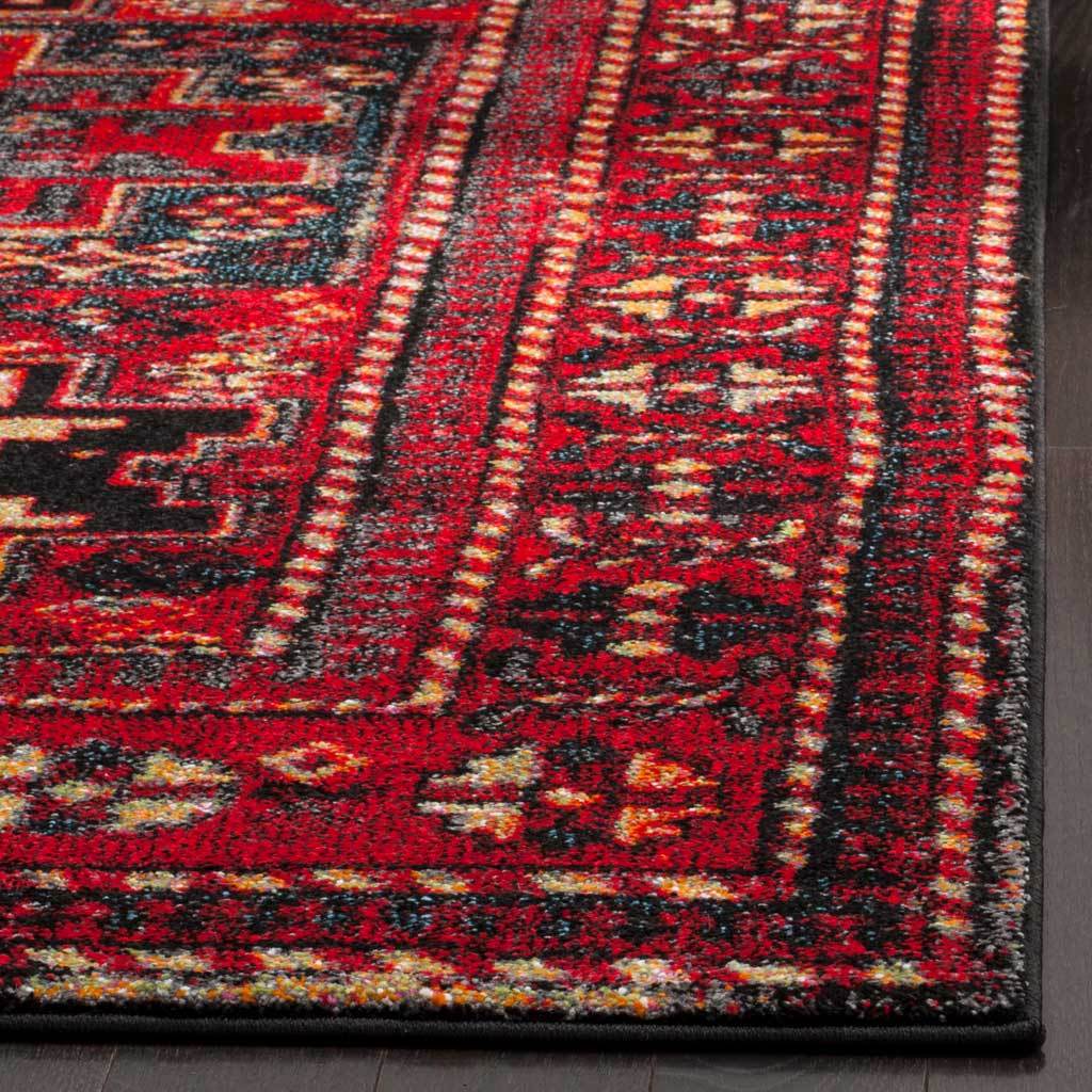 Red and black pile gives the rug's intricate border depth and texture