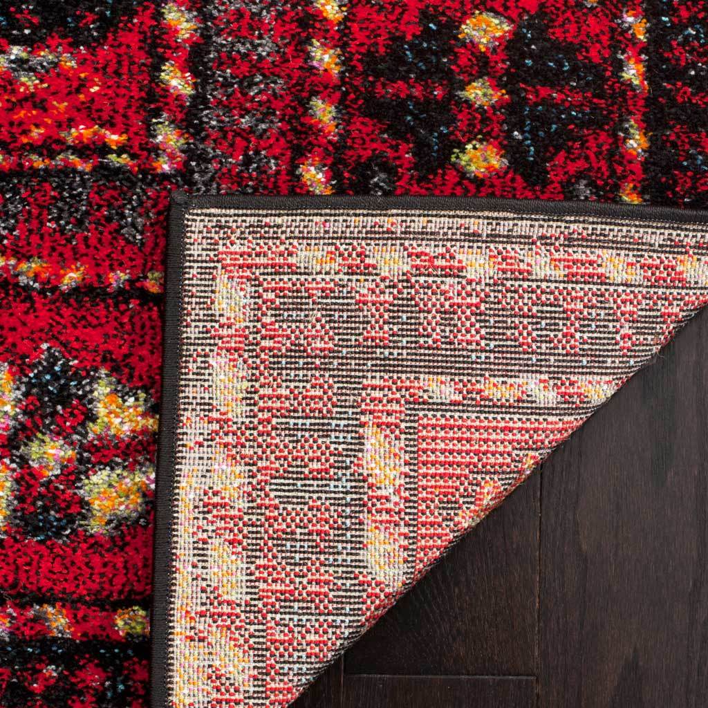 Red geometric motifs carry through to the rug's tightly woven reverse