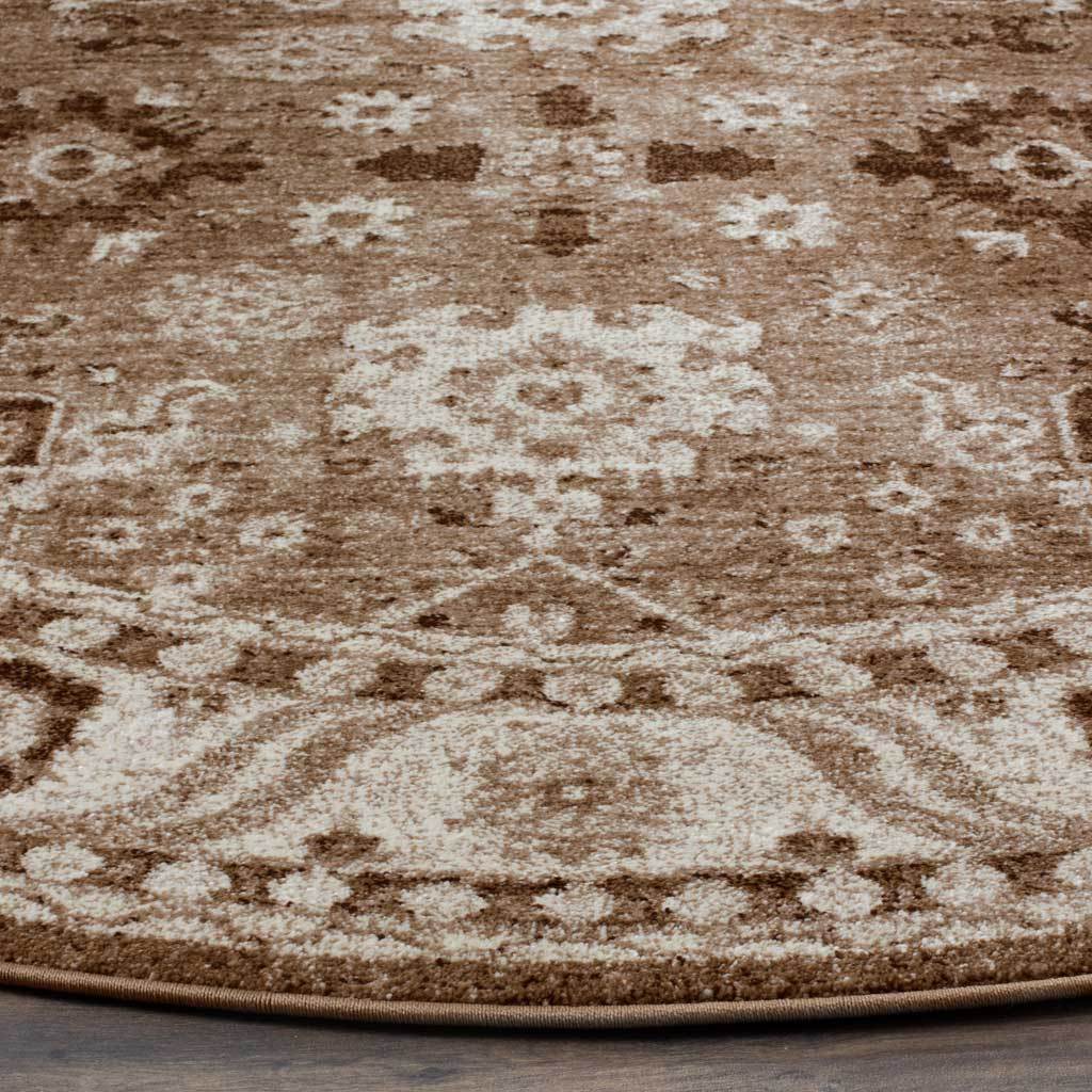 Taupe and ivory floral motifs create a gently distressed pattern above a bound edge.