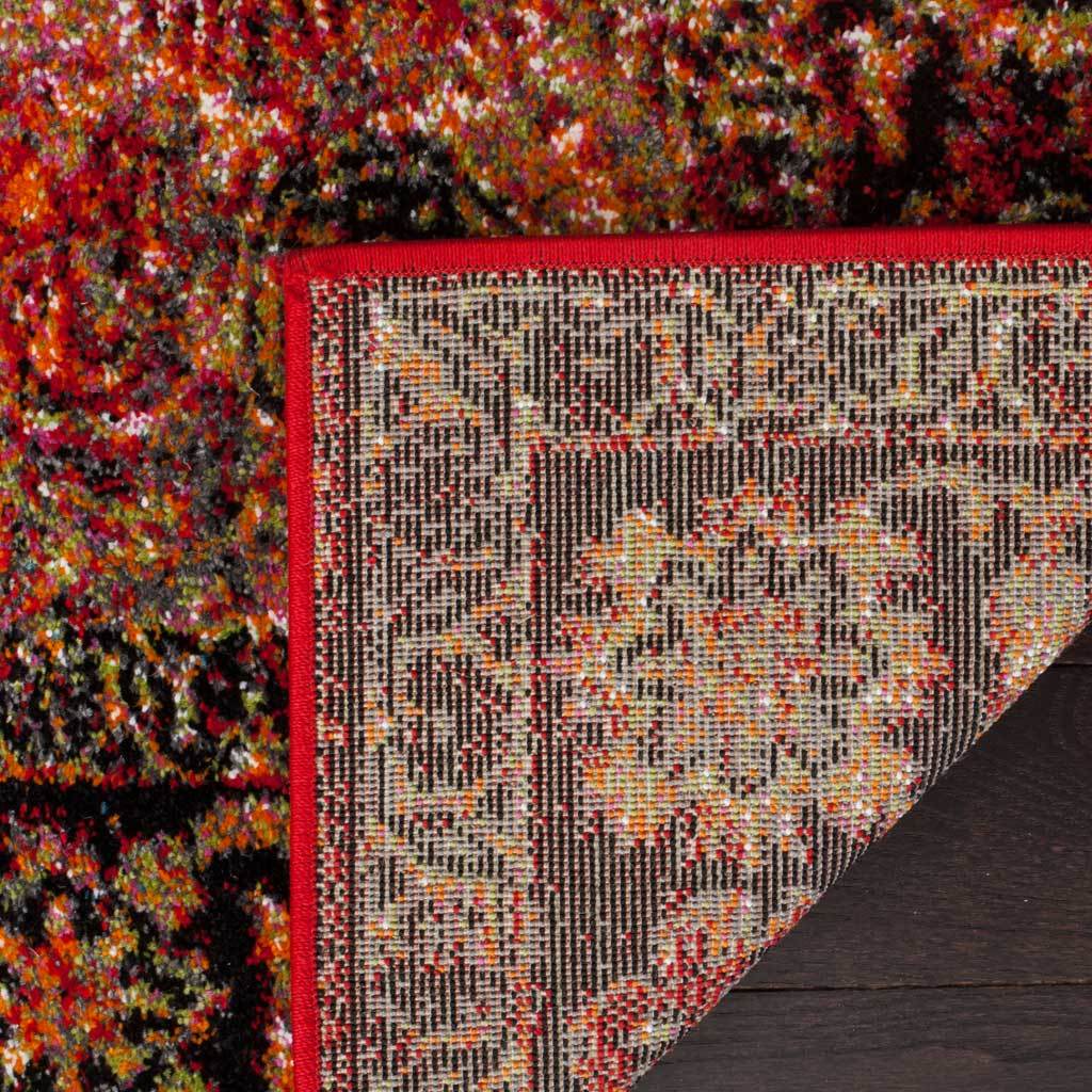 Red binding outlines the intricately patterned reverse of the floral rug