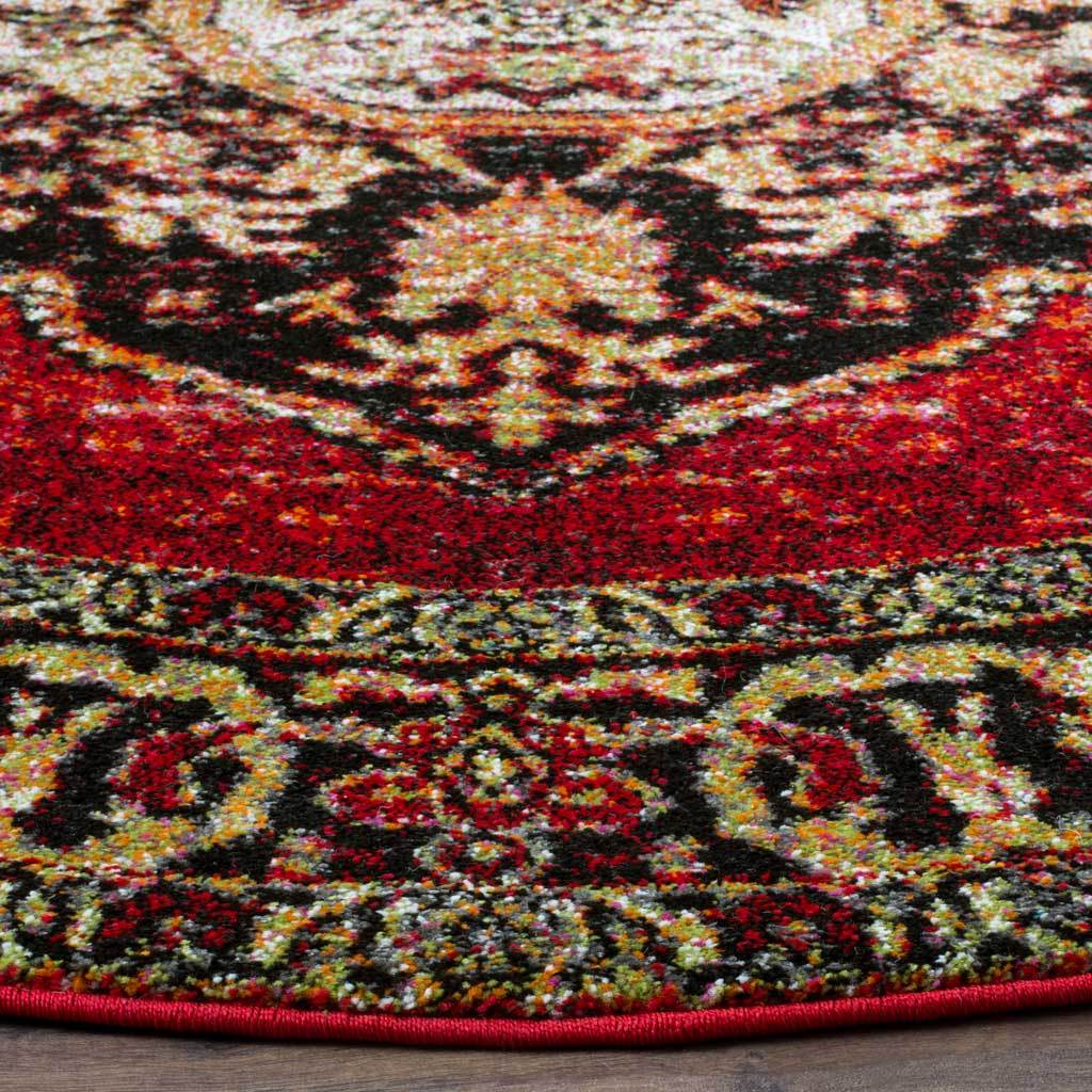 Rich red pile meets cream and black scrollwork along a neatly finished curved edge.