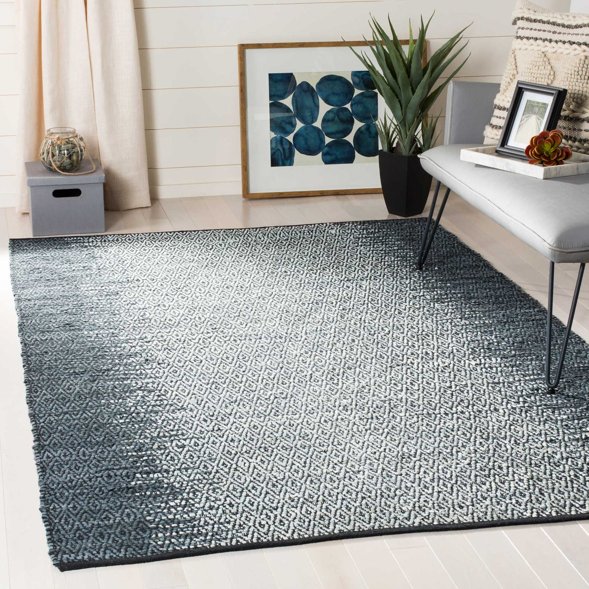 Gray and cream diamond rug balances a neutral sofa with graphic texture