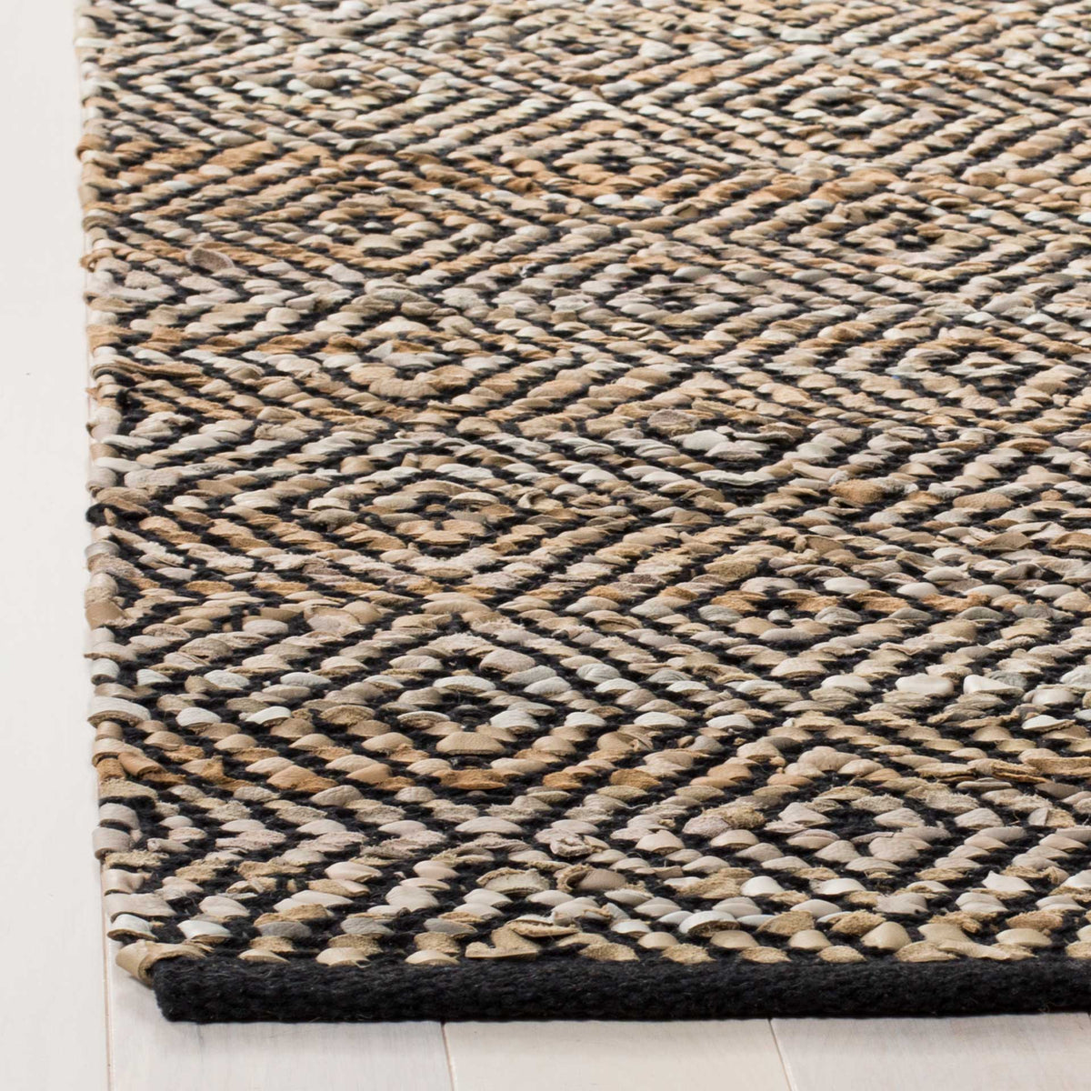 Beige leather strips and black threads form a tactile diamond pattern