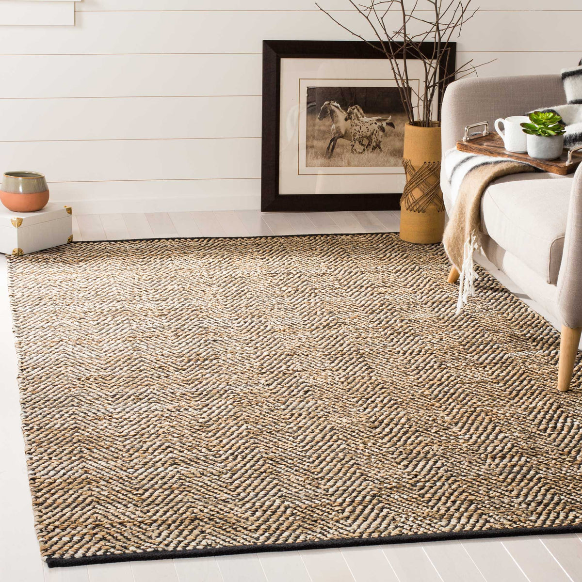 Graphic chevron rug brings woven warmth to a neutral living room