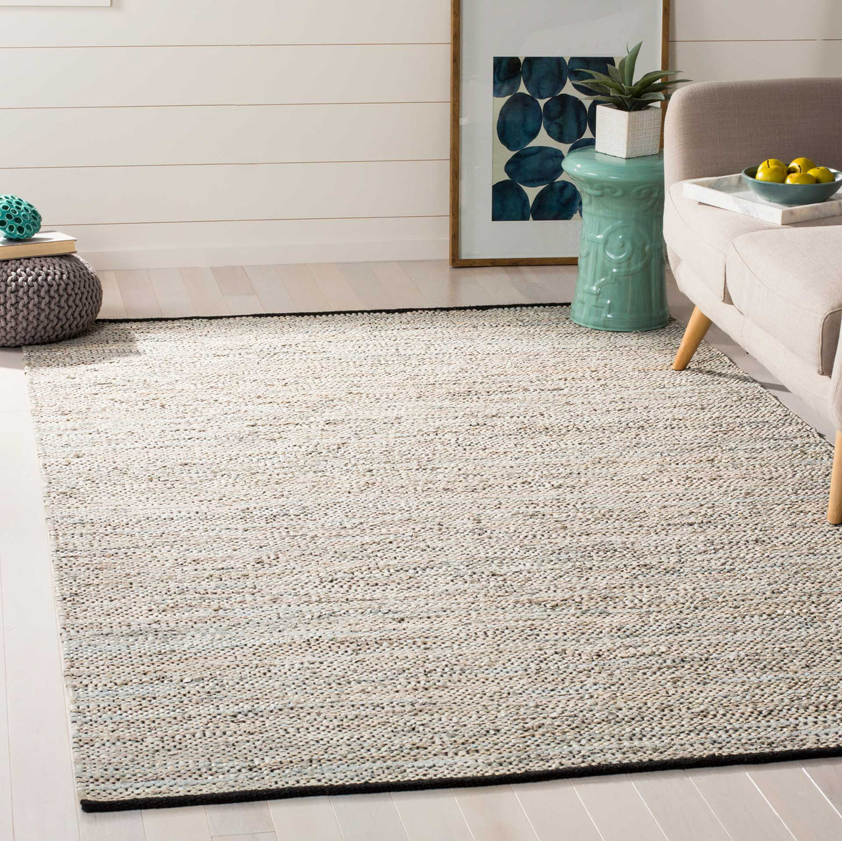 Soft beige woven rug anchors a relaxed living space with natural texture