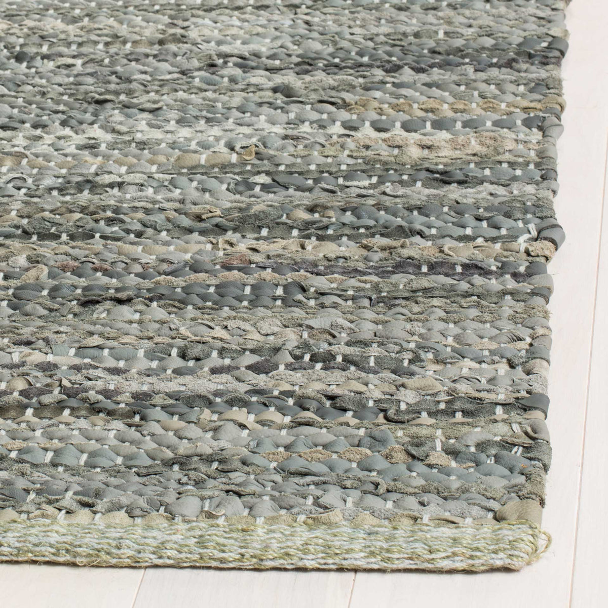 Mixed gray and cream leather strips form a textured, neatly finished edge