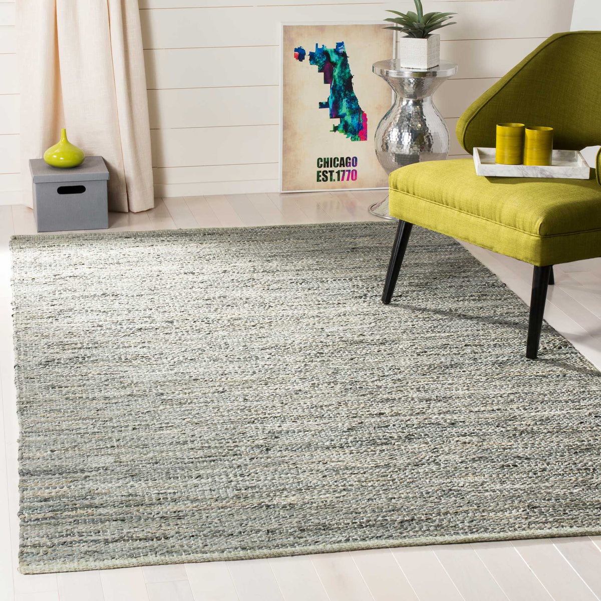 Textured gray rug complements an olive-green lounge chair