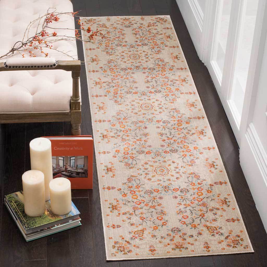 Pale gray runner blends orange blossoms with wispy blue branches in an airy design