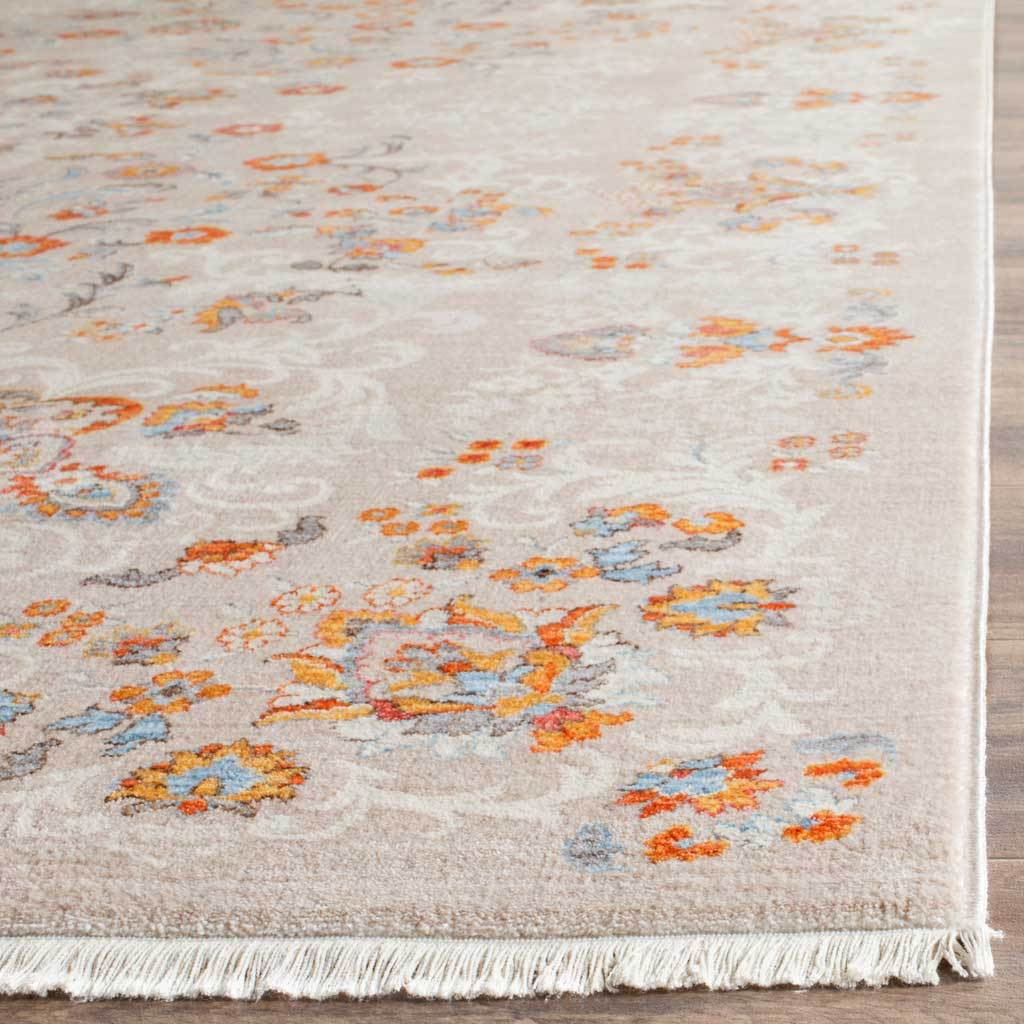 Ivory fringe finishes the airy gray rug's colorful floral detailing