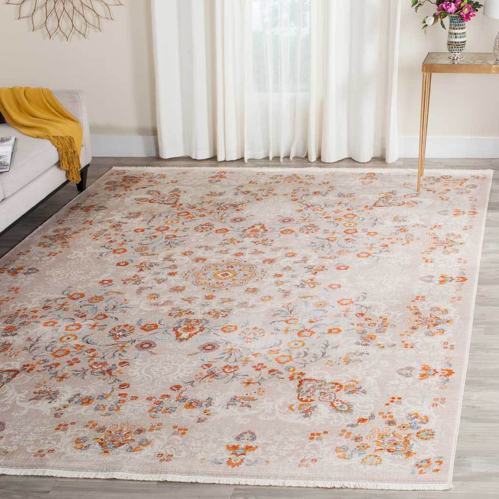 Light gray floral rug adds gentle orange and blue color to an airy room