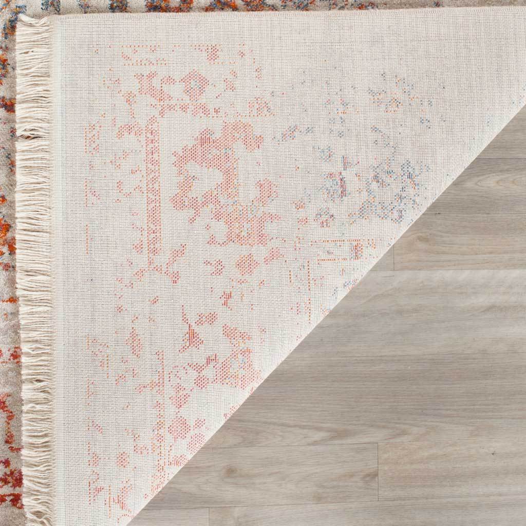 Subtle floral reverse and ivory fringe finish the light gray rug