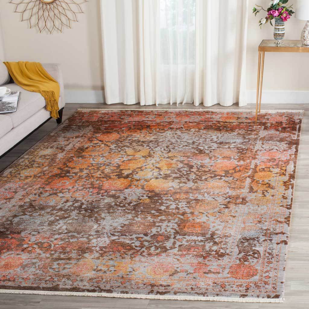 Warm brown and orange rug layers distressed florals beneath neutral furnishings