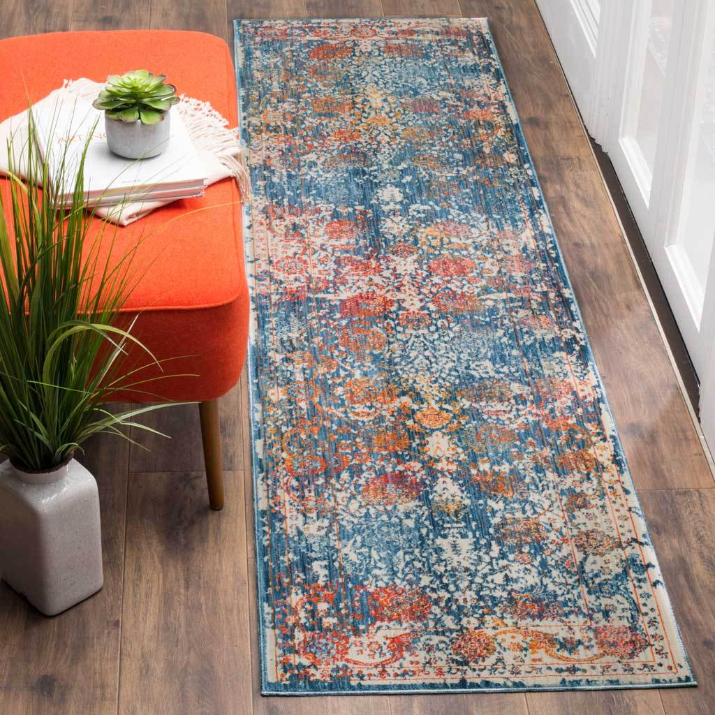 Blue-green runner mixes rust and cream floral accents into a richly faded design