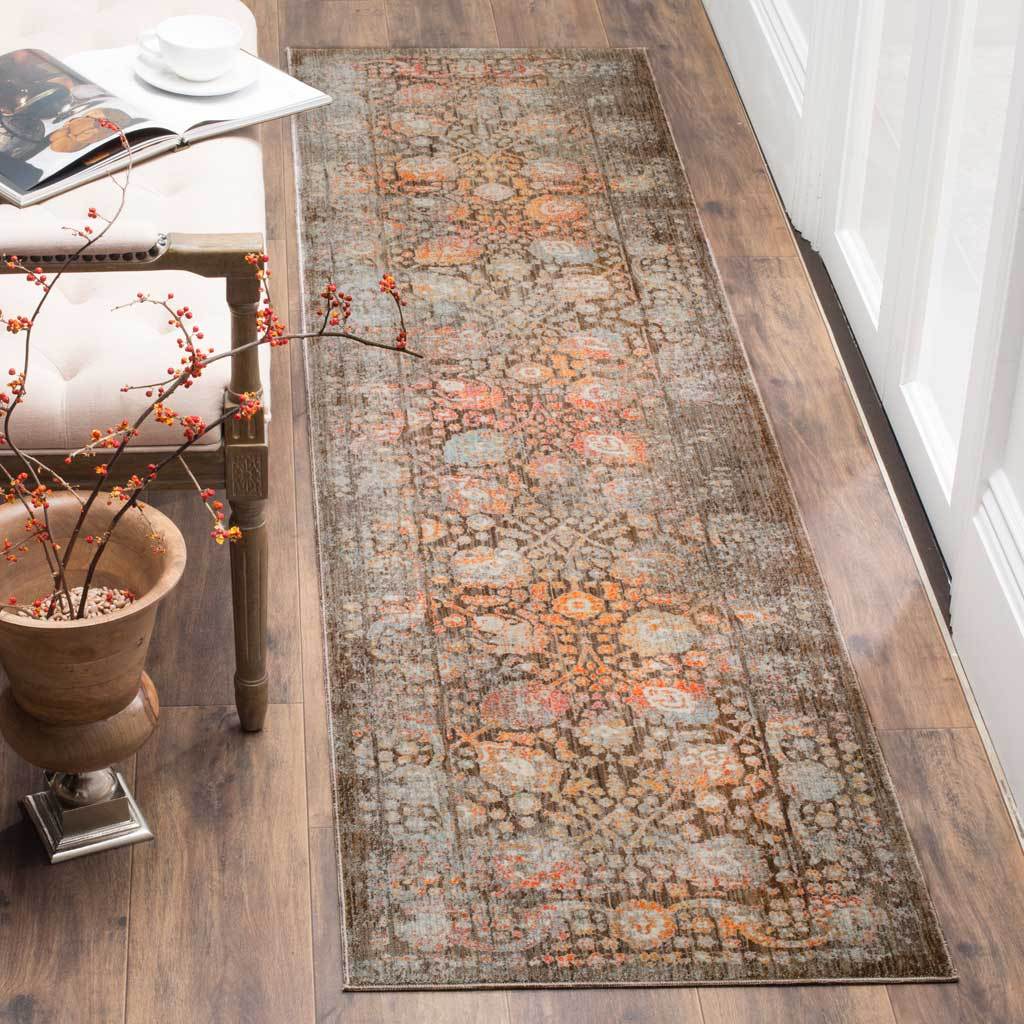 Earth-toned runner layers faded botanical motifs in brown, peach, and gray