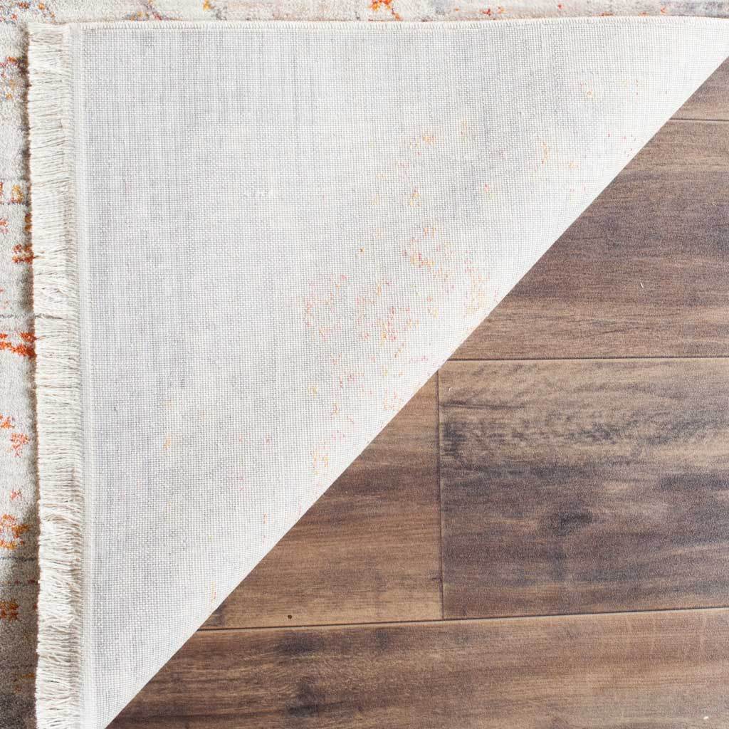 Pale cotton underside and short fringe give the patterned rug a neat finish