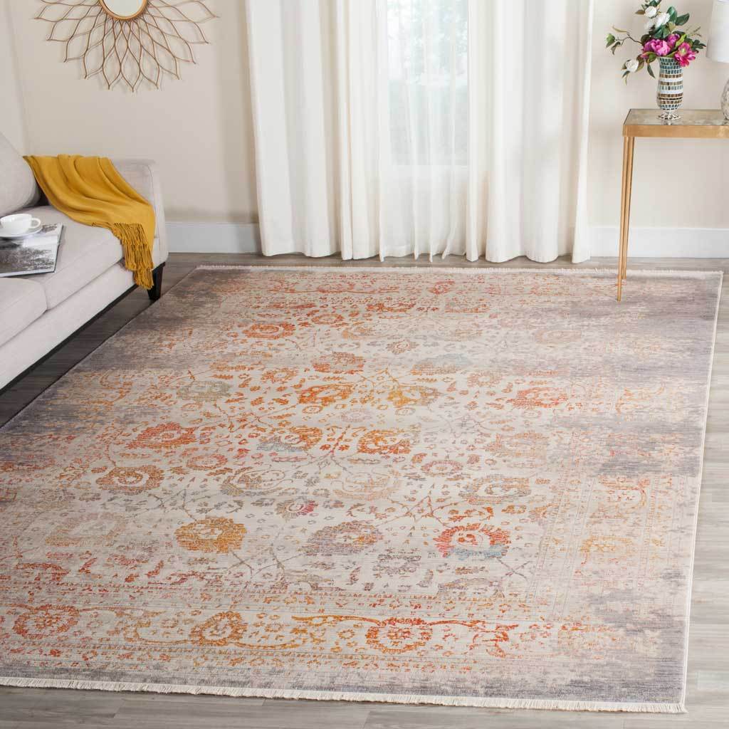 Light gray floral rug brightens a room with soft orange accents
