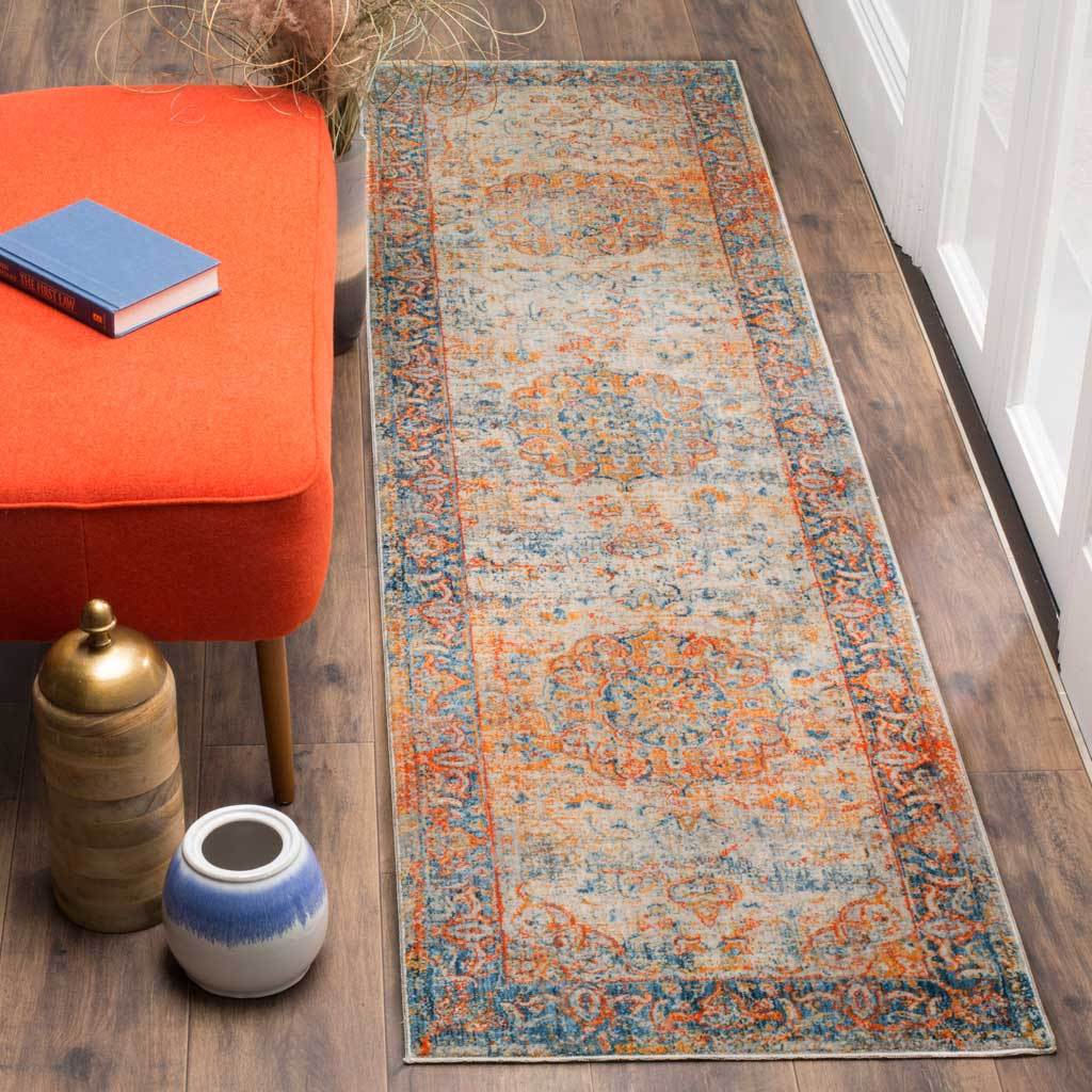 Faded blue runner highlights warm orange medallions against an ivory ground