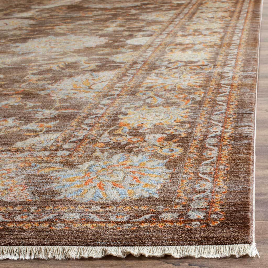 Short fringe edges the brown rug's pale blue and orange floral border