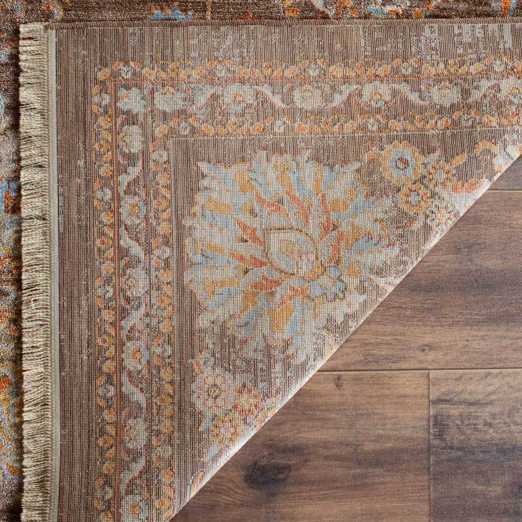 Woven reverse displays softened blue and gold floral motifs