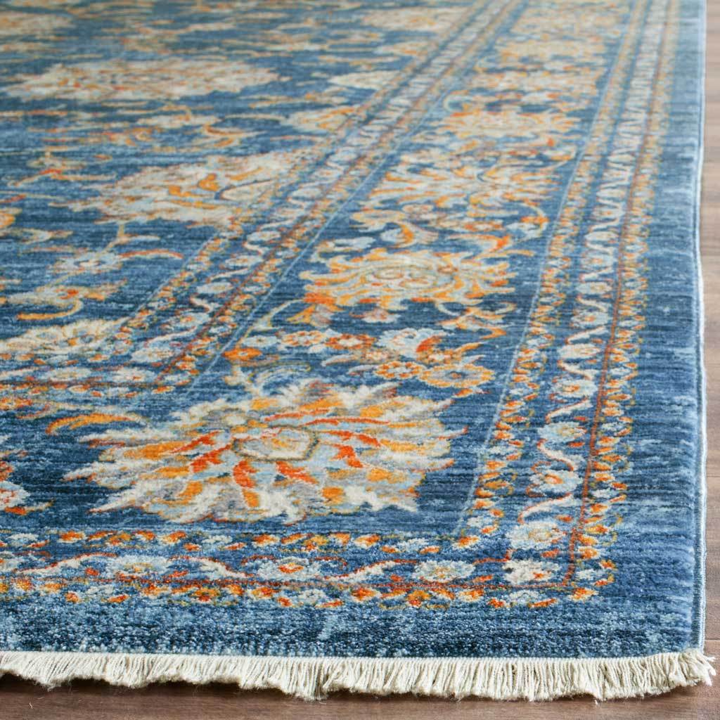Ivory fringe trims a turquoise rug with pale blue and orange floral borders