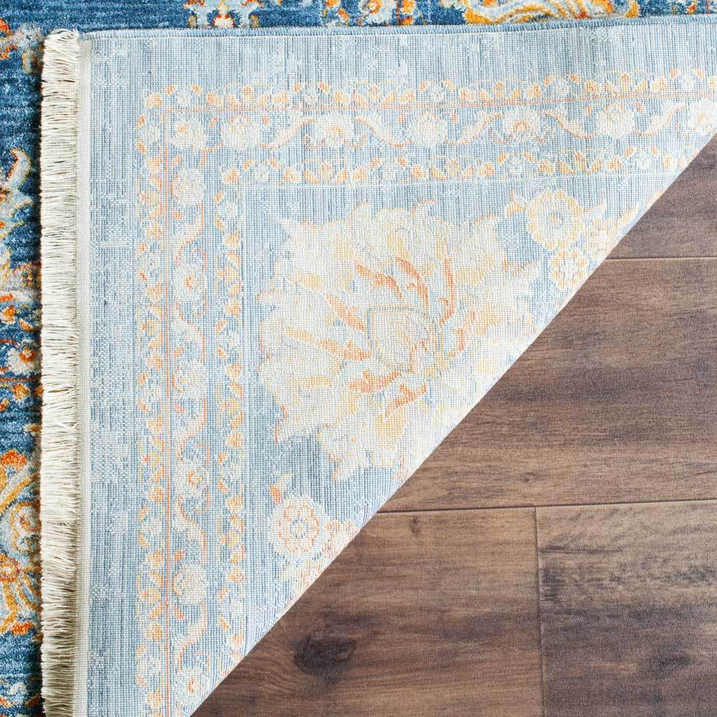 Light blue reverse weave reveals muted florals beneath the turquoise rug