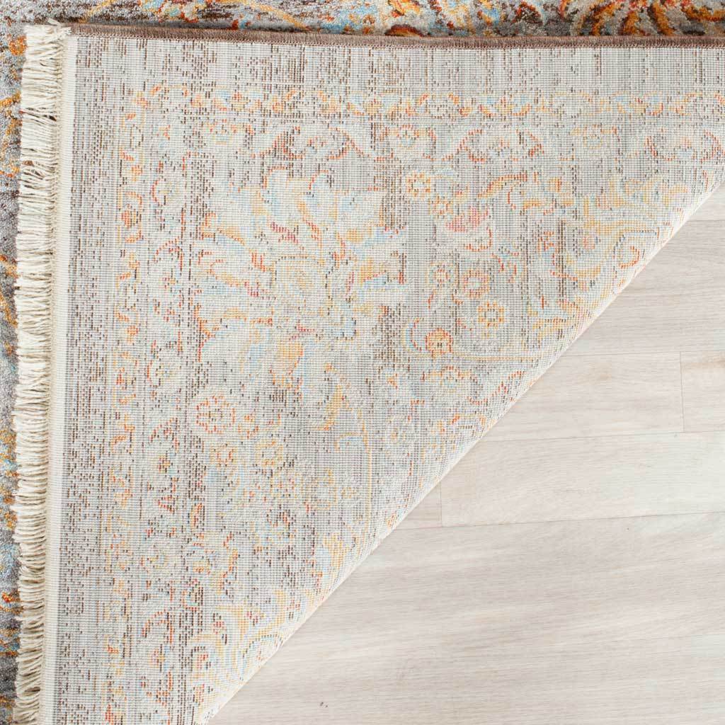 Patterned reverse and creamy fringe finish the muted floral rug